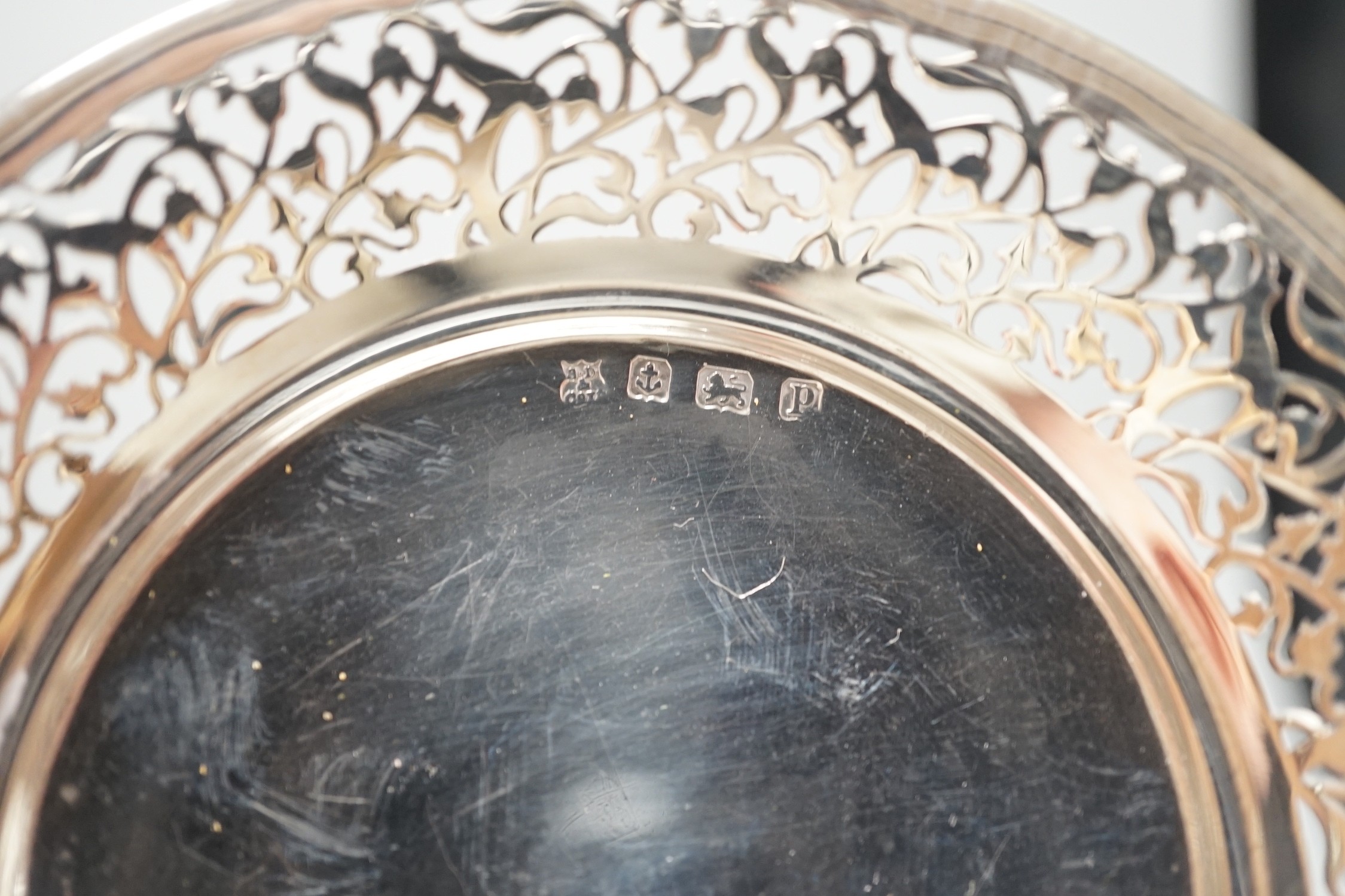 An Art Nouveau silver tripod bowl, by W.G. Connell, London, 1901, diameter 13cm, a later silver pedestal dish and modern silver sugar caster, 19cm, 11.4oz.